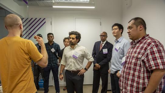 Alumni listen as a member of the Veterans Future Lab gives a presentation on his project