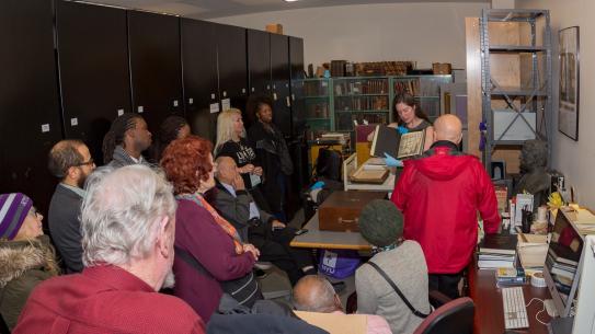 Alumni watch a demonstration by Poly archivist Lindsay Anderberg