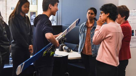 student holding a ski