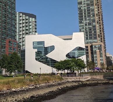 jigsaw piece looking building with high rises in background