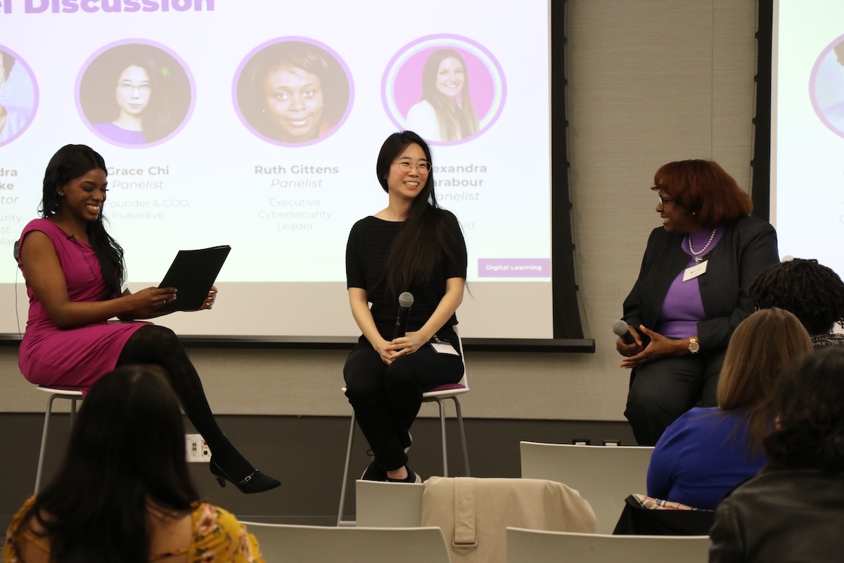 a panel of female speakers on stage