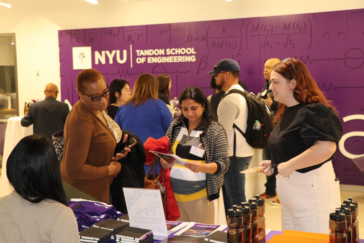 Event participants reviewing literature at a table